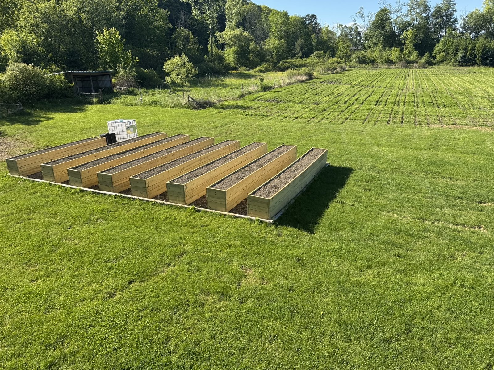 Raised garden beds and open fields at Tompkins Farm